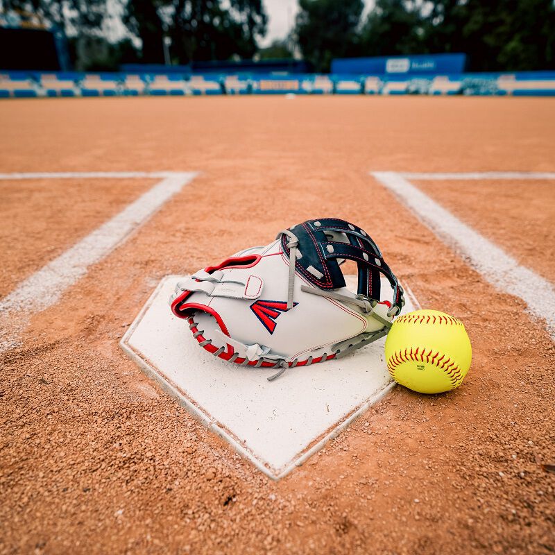 Picture of a red/white/navy Professional Collection Color Splash catcher's mitt with a ball on home plate
