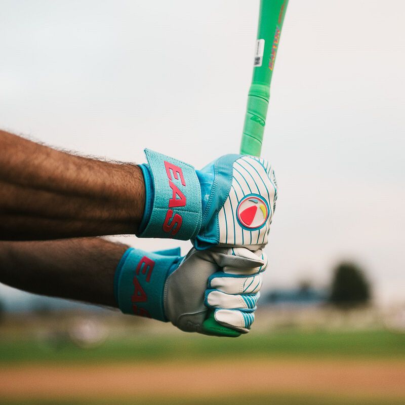 A player holding a bat with Easton Walk-Off Ethos Locked-In Pool Party batting gloves loading=