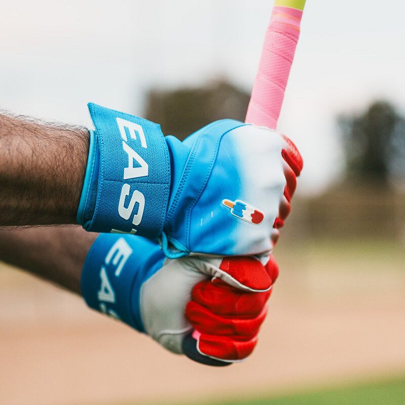 A player holding a bat with Easton Walk-Off Ethos Locked-In Rocket Pop batting gloves loading=