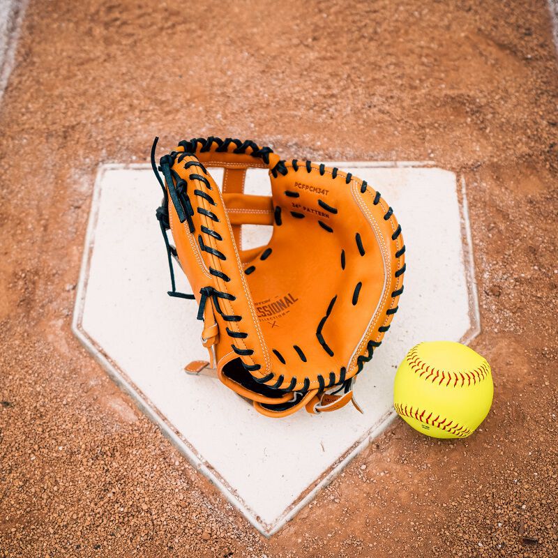 Picture of the palm of a tan Professional Collection Color Splash catcher's mitt with a ball on home plate