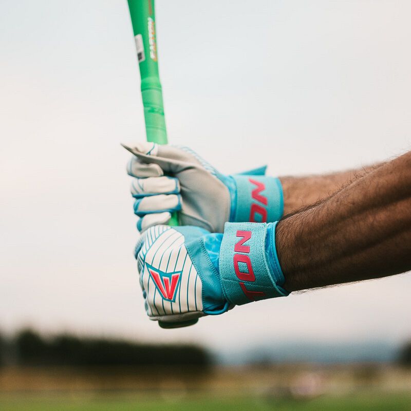 A player holding a bat with Easton Walk-Off Ethos Locked-In Pool Party batting gloves loading=