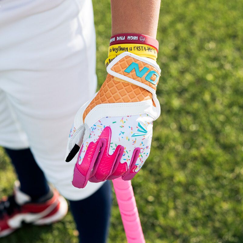 Picture of the pink left hand Walk-Off Ethos batting glove on a player's hand