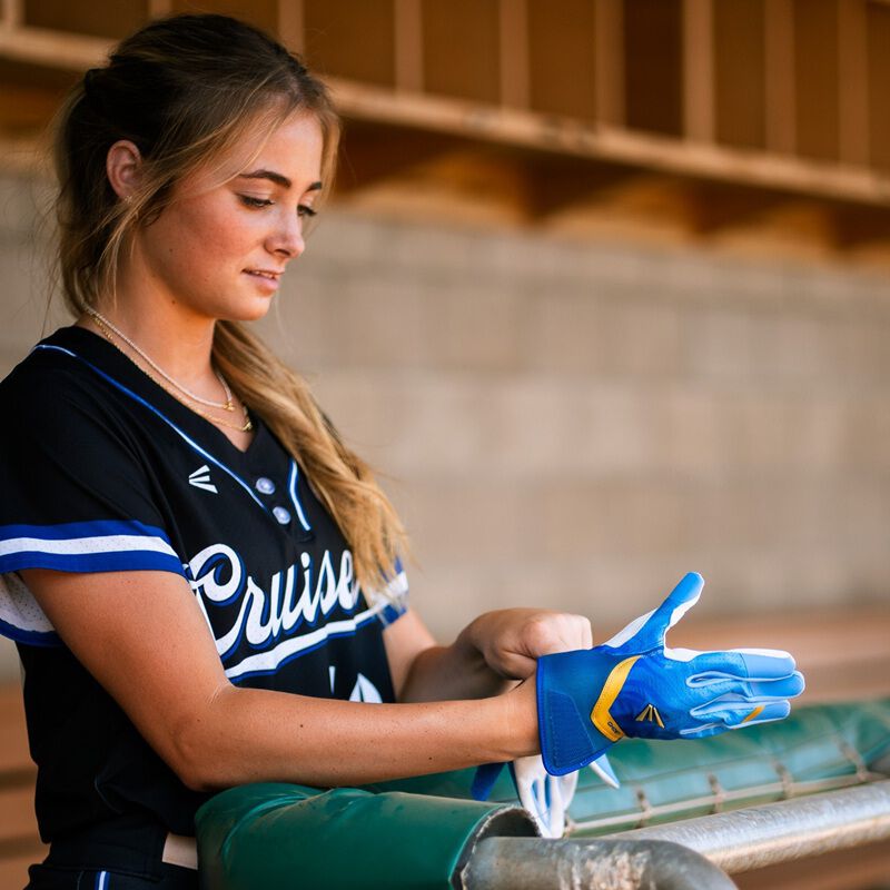 Picture of a player putting on a blue Ghost Ethos Out of the Blue fastpitch batting glove