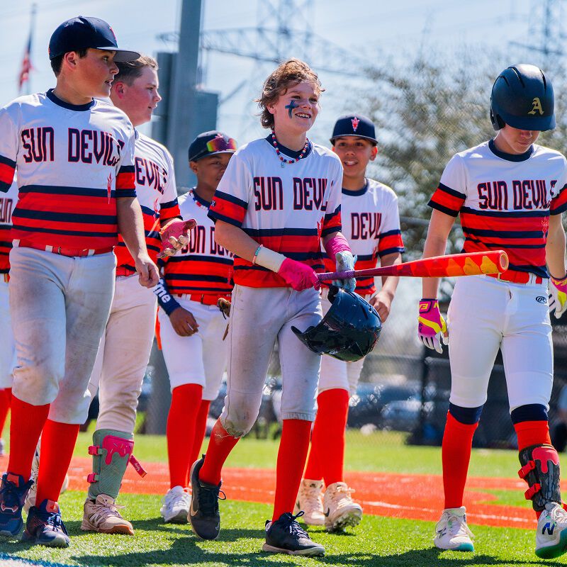 A player with a 2025 Hype Fire USSSA bat with his teammates