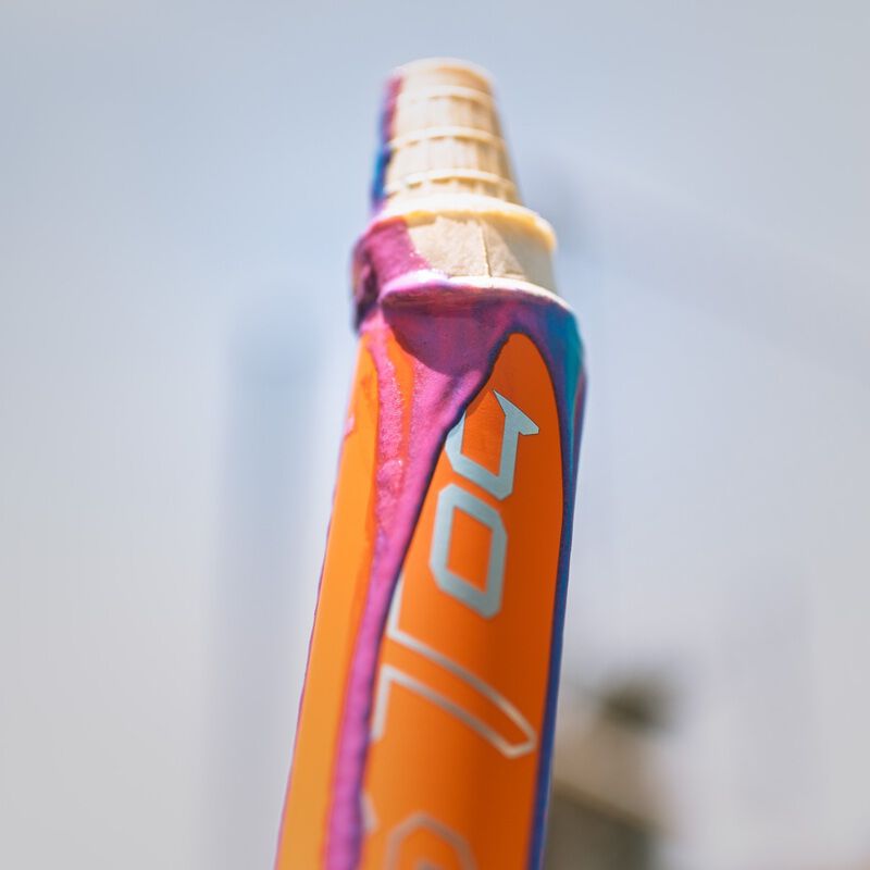 Picture of a sherbet ice cream cone melted on the end of an Easton Ghost OG Rainbow sherbet fastpitch bat loading=