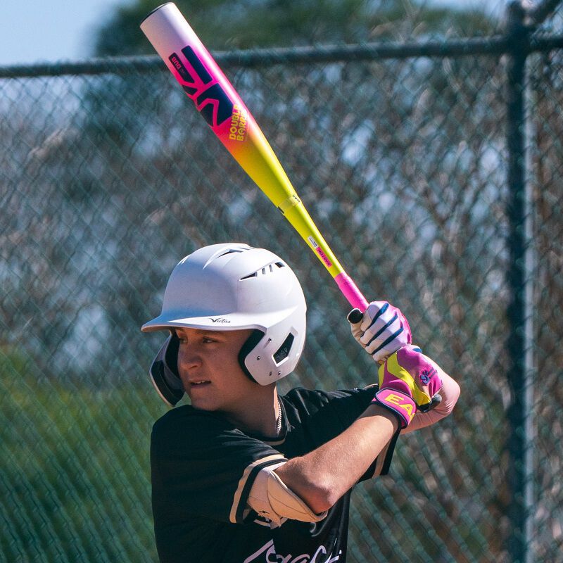 A player batting with a Dub bat and Walk-Off Ethos Dub batting gloves