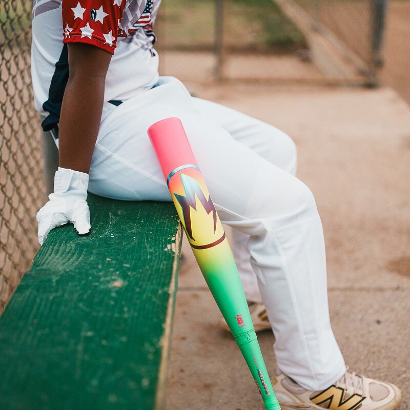 Picture of a 2026 Easton Hype Fire USA Baseball bat leaning against a bench next to a player