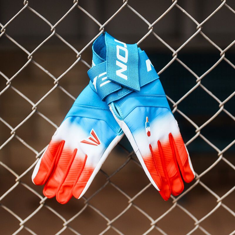 A pair of Easton Walk-Off Ethos Locked-In Rocket Pop batting gloves connected to a fence