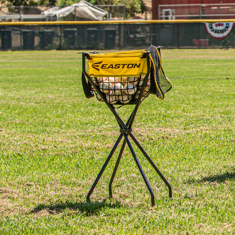 A picture of an Easton Ball Caddy on a field with baseballs loading=