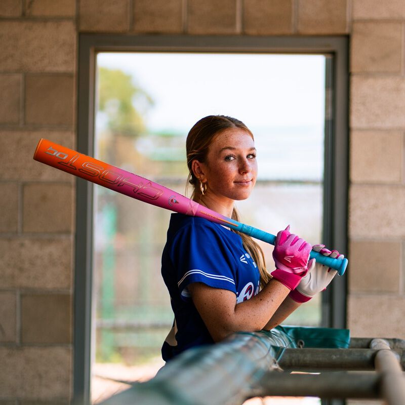 Picture of a player holding an Easton Ghost OG Rainbow sherbet fastpitch bat