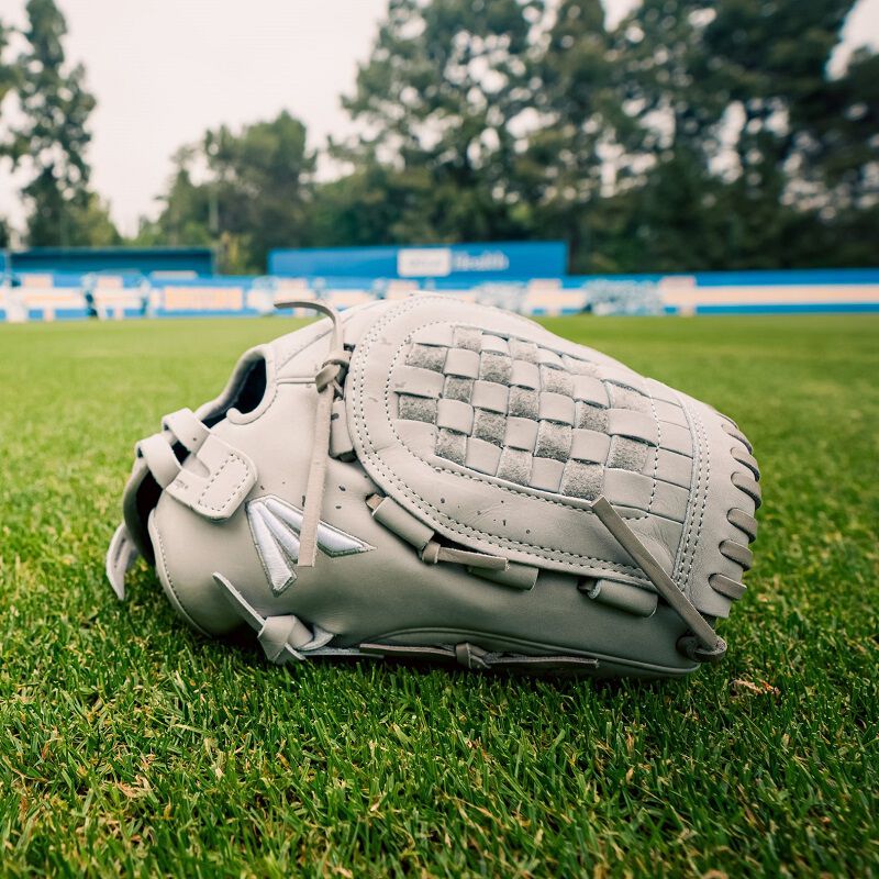 A gray Professional Collection Color Splash 12.5" utility glove on a field