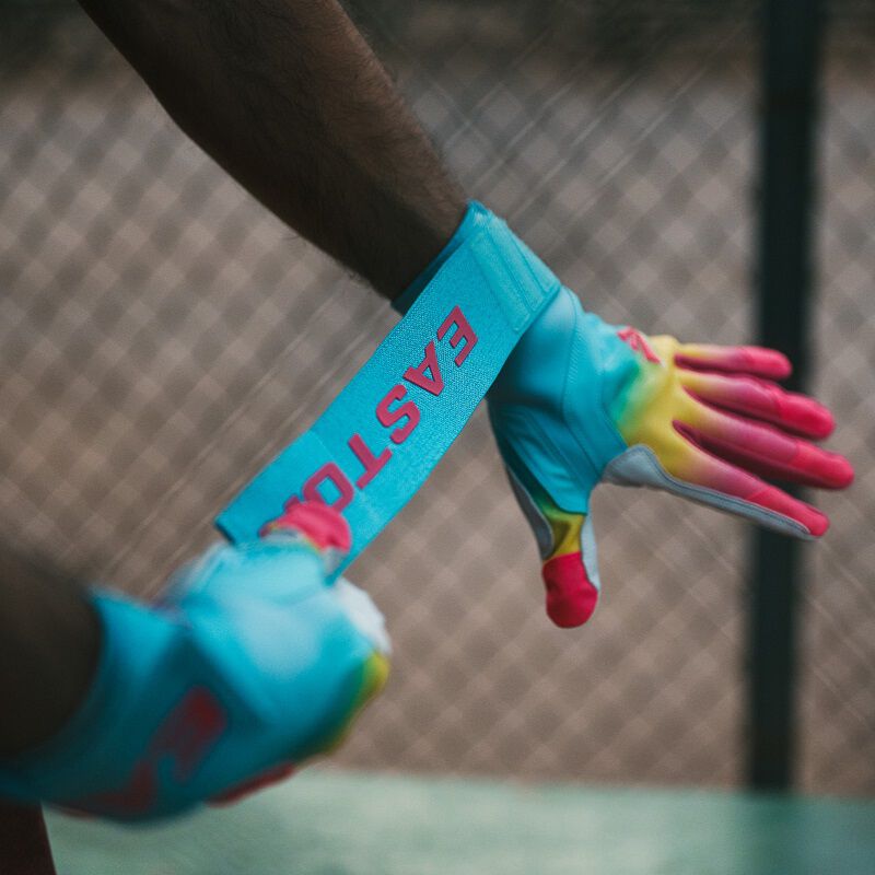 A player putting on an Eason Walk-Off Ethos Locked-In Fire batting gloves