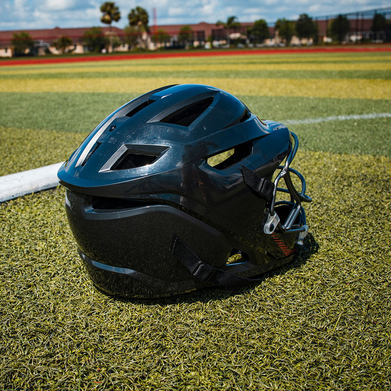 Back of a black Hellcat fielding slowpitch helmet sitting on a field - SKU: EHCATH