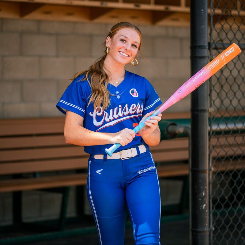 Picture of a player standing with an Easton Ghost OG Rainbow sherbet fastpitch bat