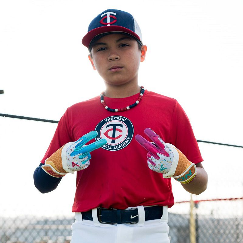 Picture of a player holding up double "peace" signs wearing Walk-Off Ethos Sugar Rush batting gloves