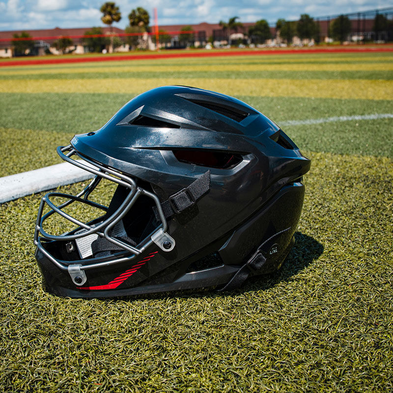 Left side of a black Hellcat fielding helmet on a field - SKU: EHCATH