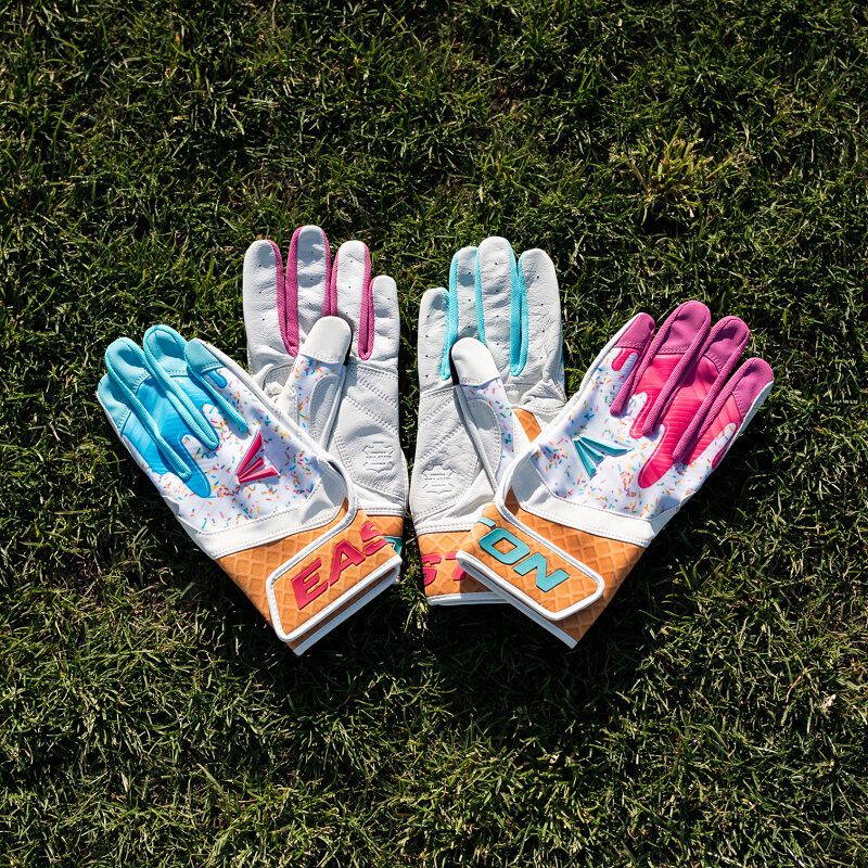 Picture of two pairs of Walk-Off Ethos Sugar Rush batting gloves in the grass