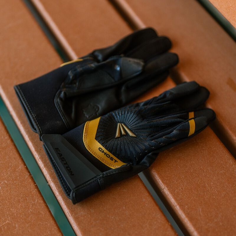 Picture of a pair of black Ghost Ethos Midnight Sky fastpitch batting gloves on a bench