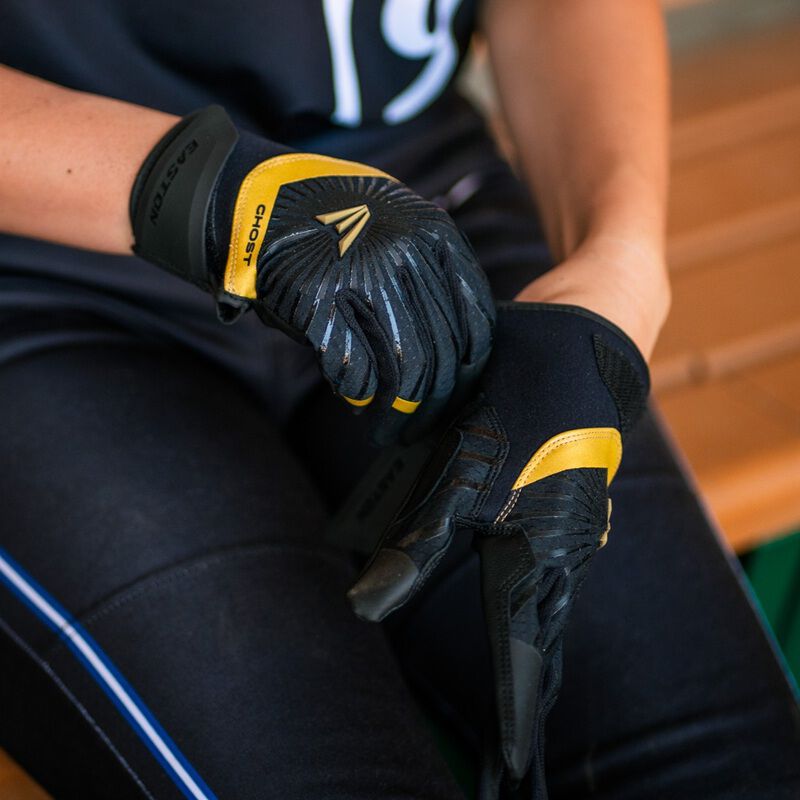 Picture of a player putting on a black Ghost Ethos Midnight Sky fastpitch batting glove