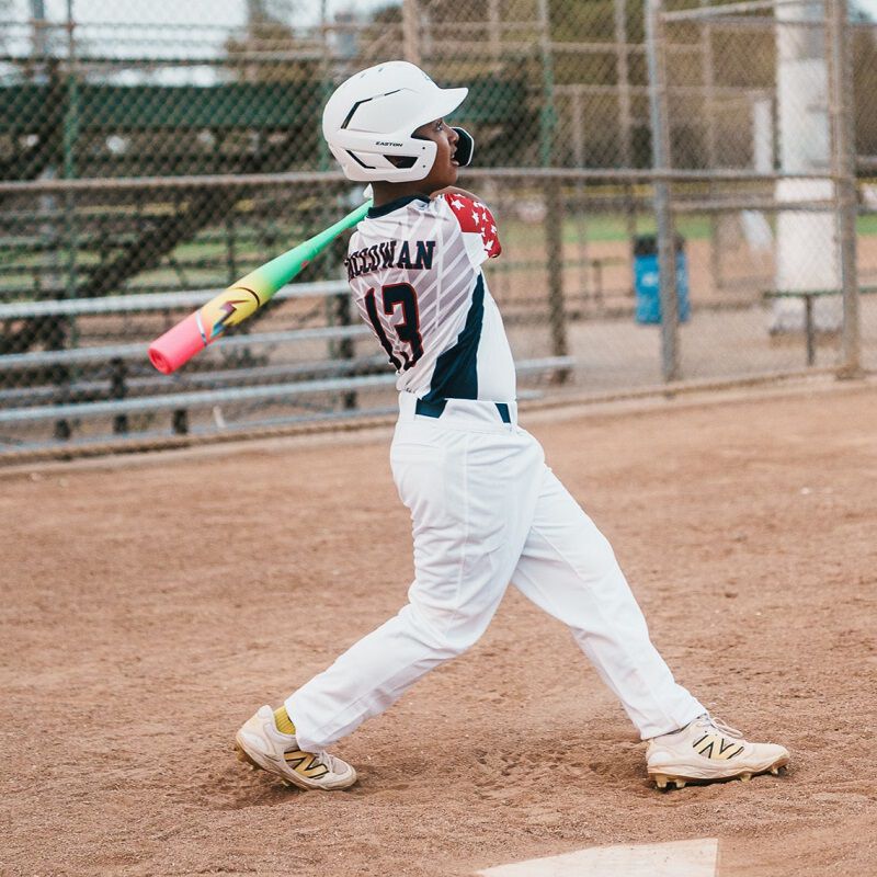 Picture of a player finishing his swing with a 2026 Easton Hype Fire USA Baseball bat