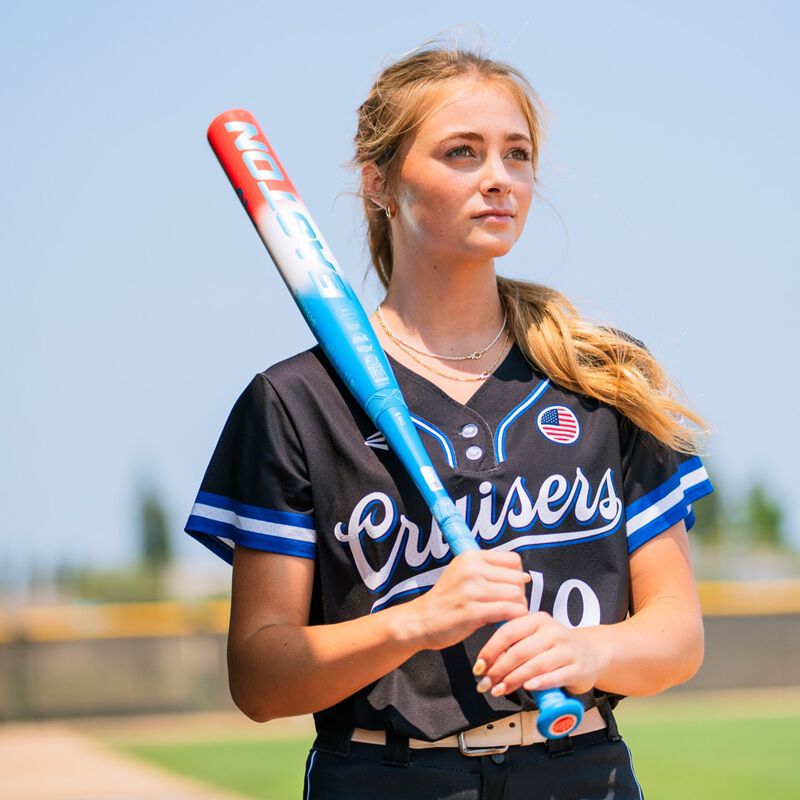 A fastpitch player with a red/white/blue Easton Ghost OG Rocket Pop fastpitch bat on her shoulder