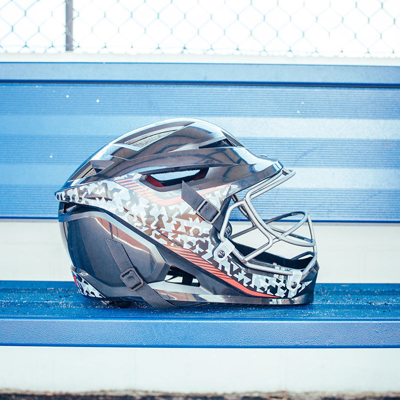 Right side of a Hellcat Mojo slowpitch pitcher's helmet on a bench in a dugout - SKU: HELMOSPH loading=