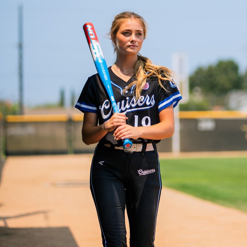 A fastpitch player holding a red/white/blue Easton Ghost OG Rocket Pop fastpitch bat