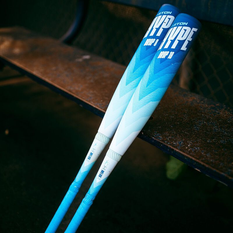 A picture of a two limited edition Hype Fire Arctic Flame USSSA bats leaning against a bench