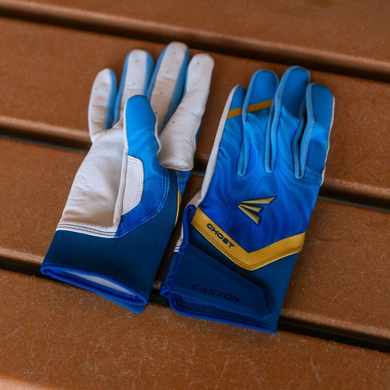 Picture of a pair of blue Ghost Ethos Out of the Blue fastpitch batting gloves on a bench