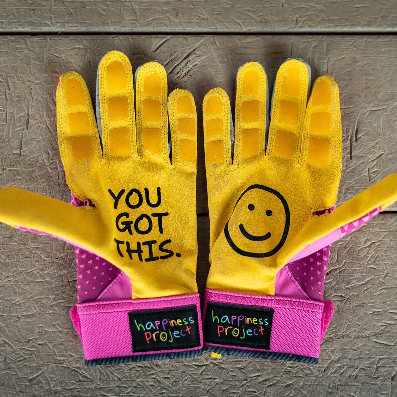 Picture of the yellow palms of a pair of pink Easton x Happiness Project Ghost NX fastpitch batting gloves