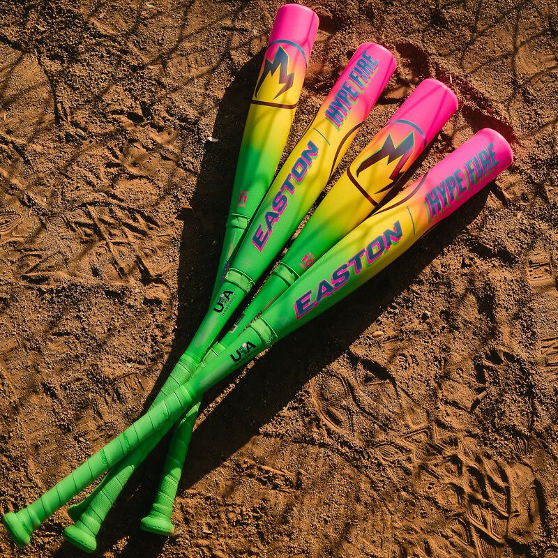 Picture of four 2026 Easton Hype Fire USA Baseball bats laying in the dirt