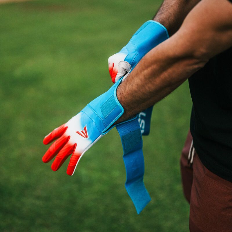 A player putting on an Easton Walk-Off Ethos Locked-In Rocket Pop batting glove loading=