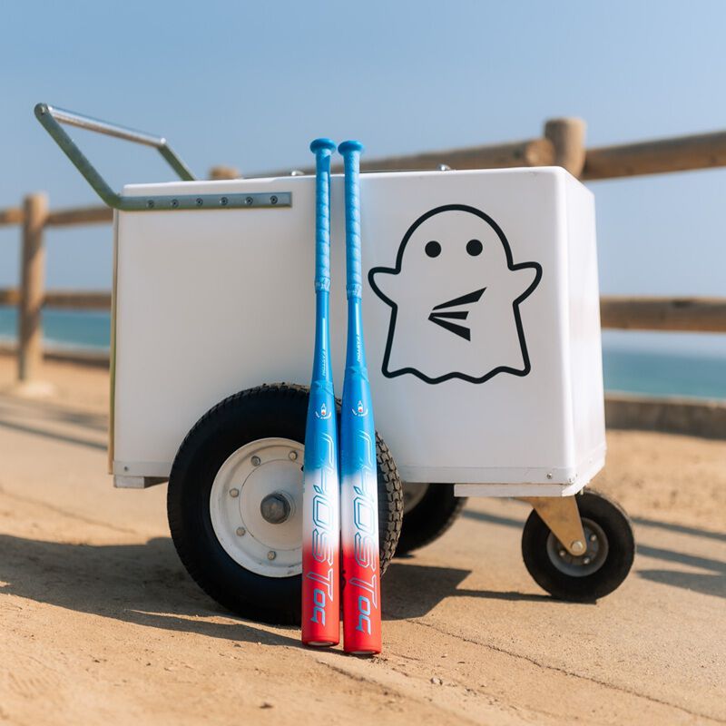 A red/white/blue Easton Ghost OG Rocket Pop fastpitch bat leaned against an ice cream stand